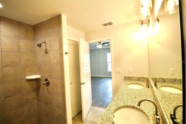 9 Hemlock Terrace Ln, Ocala, FL 34472 - full bath with a tile shower, double vanity, ceiling fan, a textured ceiling, and tile patterned flooring
