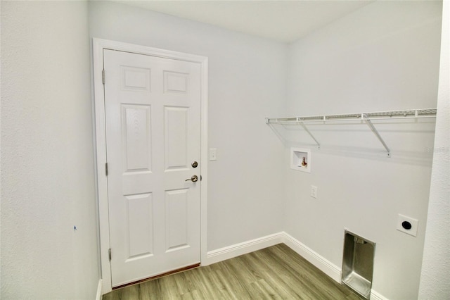 9 Hemlock Terrace Ln, Ocala, FL 34472 - laundry room with wood finished floors, electric dryer hookup, and hookup for a washing machine