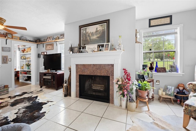 581 NE 44th Ave, Ocala, FL 34470 - living area with a fireplace with flush hearth, ceiling fan, light tile patterned floors, and healthy amount of natural light