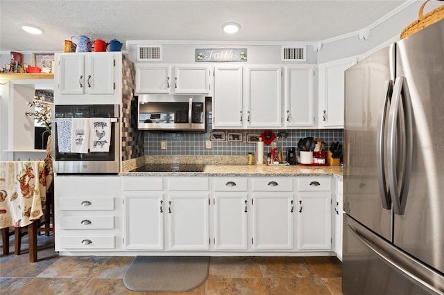 581 NE 44th Ave, Ocala, FL 34470 - kitchen with stainless steel appliances, white cabinetry, light stone counters, and crown molding