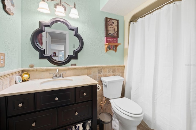 581 NE 44th Ave, Ocala, FL 34470 - bathroom featuring tile walls, wainscoting, vanity, and a shower with shower curtain