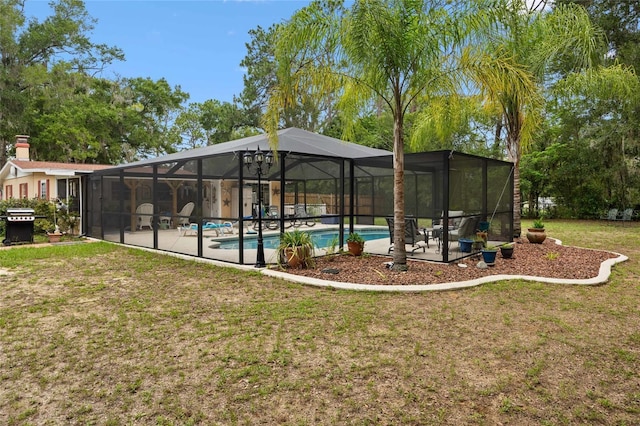 581 NE 44th Ave, Ocala, FL 34470 - swimming pool featuring a patio area, a lawn, glass enclosure, and grilling area