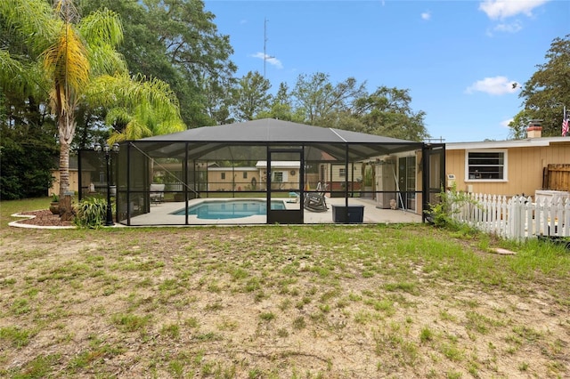 581 NE 44th Ave, Ocala, FL 34470 - back of property with an outdoor pool, a patio area, and glass enclosure