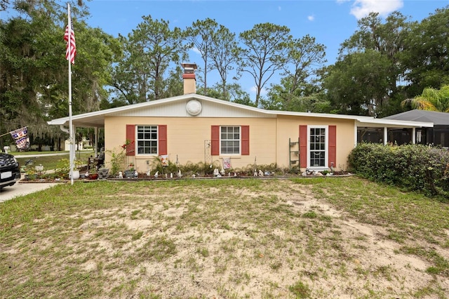 581 NE 44th Ave, Ocala, FL 34470 - ranch-style house featuring a front lawn and a chimney