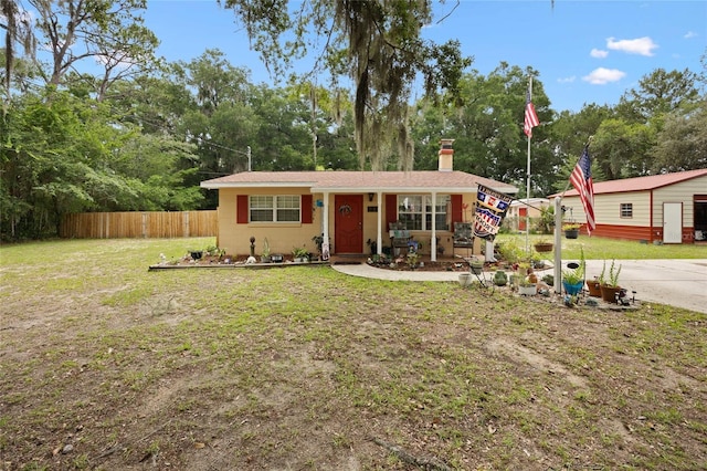 581 NE 44th Ave, Ocala, FL 34470 - view of front facade with a chimney, a porch, and view of wooded area