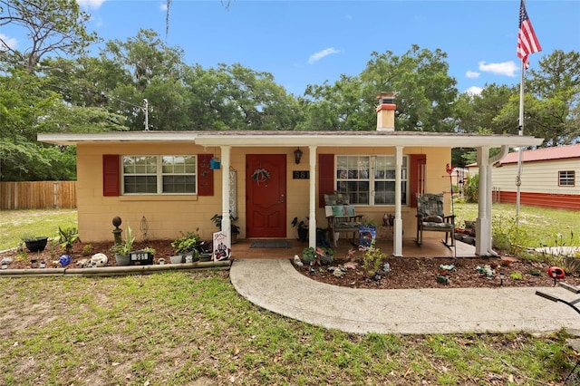 581 NE 44th Ave, Ocala, FL 34470 - view of front of property with covered porch, a chimney, and concrete block siding