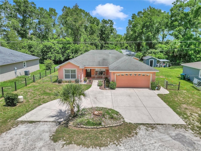 3453 SE 147th Ln, Summerfield, FL 34491 - single story home featuring driveway, a garage, covered porch, stucco siding, and roof with shingles