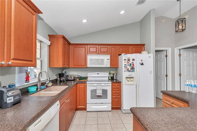 3453 SE 147th Ln, Summerfield, FL 34491 - kitchen with white appliances, vaulted ceiling, light tile patterned floors, decorative light fixtures, and brown cabinetry