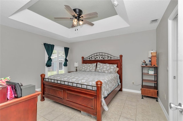 3453 SE 147th Ln, Summerfield, FL 34491 - bedroom featuring a tray ceiling, light tile patterned floors, and ceiling fan