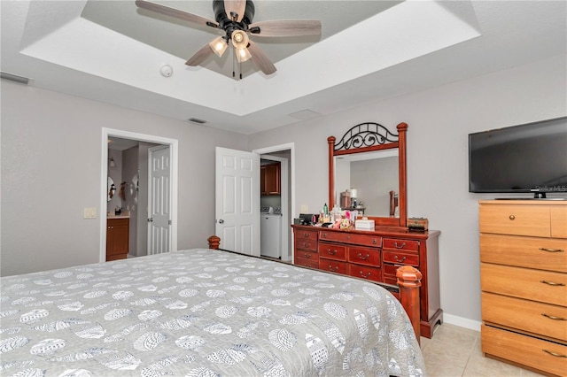 3453 SE 147th Ln, Summerfield, FL 34491 - bedroom featuring a raised ceiling, light tile patterned floors, and separate washer and dryer