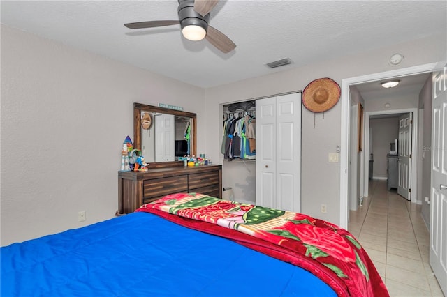 3453 SE 147th Ln, Summerfield, FL 34491 - bedroom with tile patterned floors, a closet, a ceiling fan, and a textured ceiling