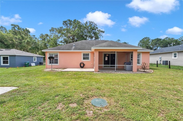 3453 SE 147th Ln, Summerfield, FL 34491 - back of house with a patio area, a lawn, a sunroom, and stucco siding