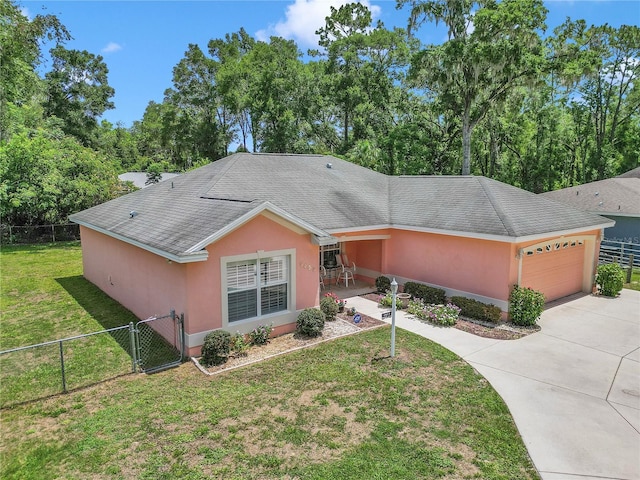 3453 SE 147th Ln, Summerfield, FL 34491 - single story home with a garage, concrete driveway, a gate, stucco siding, and a shingled roof