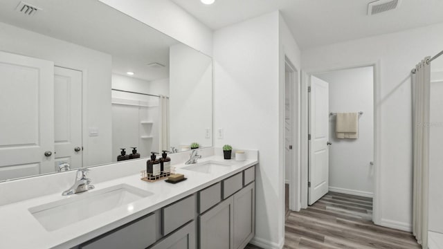 13261 SW 56th Ter, Ocala, FL 34473 - bathroom with double vanity, wood finished floors, and a shower with curtain