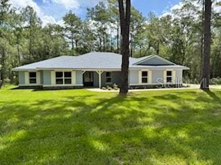 1467 E Odin Dr, Citrus Springs, FL 34434 - ranch-style house featuring a front lawn and view of scattered trees