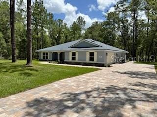 1467 E Odin Dr, Citrus Springs, FL 34434 - view of front of home featuring decorative driveway and a front yard