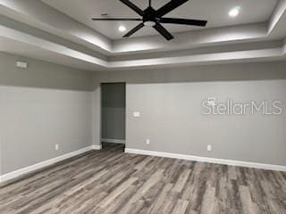 1467 E Odin Dr, Citrus Springs, FL 34434 - unfurnished room with a raised ceiling, wood finished floors, recessed lighting, and a ceiling fan