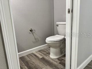 1467 E Odin Dr, Citrus Springs, FL 34434 - bathroom featuring wood finished floors and toilet