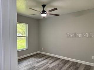1467 E Odin Dr, Citrus Springs, FL 34434 - unfurnished room featuring ceiling fan and dark wood-type flooring