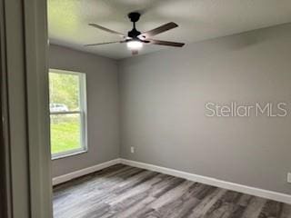 1467 E Odin Dr, Citrus Springs, FL 34434 - unfurnished room with dark wood finished floors and ceiling fan