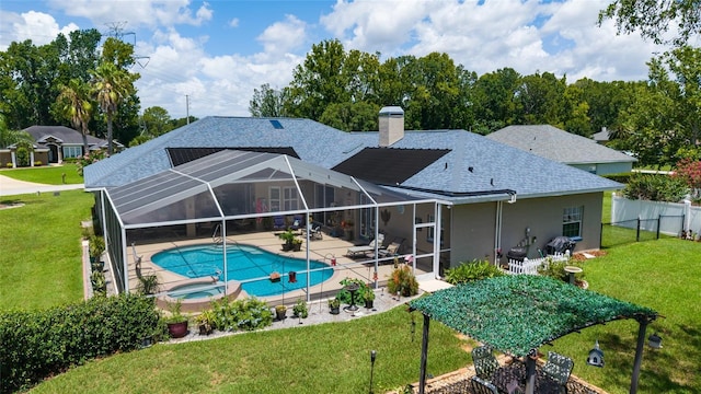 3629 SE 54th Ave, Ocala, FL 34480 - back of property featuring a patio area, a shingled roof, a chimney, a pool with connected hot tub, and stucco siding