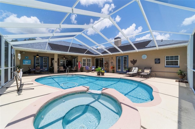 3629 SE 54th Ave, Ocala, FL 34480 - view of pool featuring french doors, a ceiling fan, a patio, a pool with connected hot tub, and glass enclosure