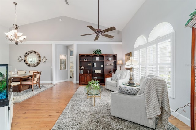 3629 SE 54th Ave, Ocala, FL 34480 - living area featuring light wood-type flooring, a chandelier, a ceiling fan, and high vaulted ceiling