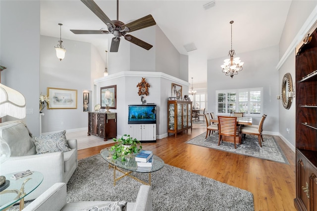3629 SE 54th Ave, Ocala, FL 34480 - living room featuring high vaulted ceiling, a chandelier, wood finished floors, and ceiling fan