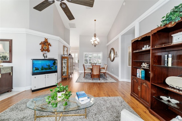 3629 SE 54th Ave, Ocala, FL 34480 - living room with high vaulted ceiling, a chandelier, ceiling fan, and light wood finished floors