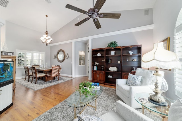 3629 SE 54th Ave, Ocala, FL 34480 - living room with ceiling fan, high vaulted ceiling, a chandelier, and wood finished floors