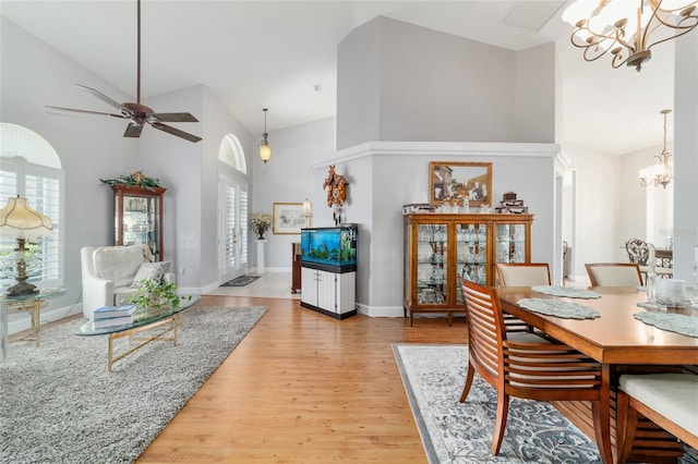 3629 SE 54th Ave, Ocala, FL 34480 - dining area featuring a chandelier, high vaulted ceiling, light wood finished floors, and ceiling fan