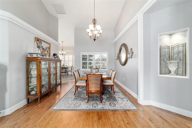 3629 SE 54th Ave, Ocala, FL 34480 - dining space featuring a chandelier, light wood-type flooring, and high vaulted ceiling