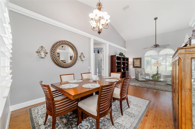 3629 SE 54th Ave, Ocala, FL 34480 - dining space with high vaulted ceiling, a chandelier, a ceiling fan, and wood finished floors