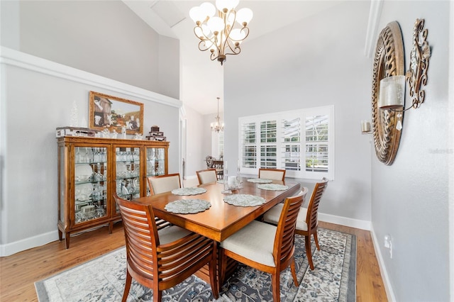 3629 SE 54th Ave, Ocala, FL 34480 - dining area featuring a chandelier, high vaulted ceiling, and wood finished floors