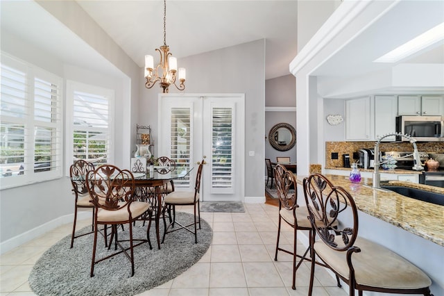 3629 SE 54th Ave, Ocala, FL 34480 - dining space featuring light tile patterned flooring, a chandelier, and vaulted ceiling