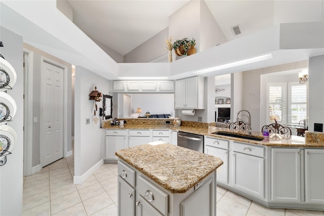 3629 SE 54th Ave, Ocala, FL 34480 - kitchen featuring dishwasher, light tile patterned floors, lofted ceiling, a kitchen island, and light stone countertops