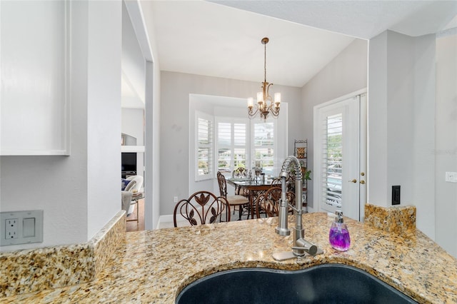 3629 SE 54th Ave, Ocala, FL 34480 - kitchen with light stone counters, a chandelier, decorative light fixtures, and lofted ceiling