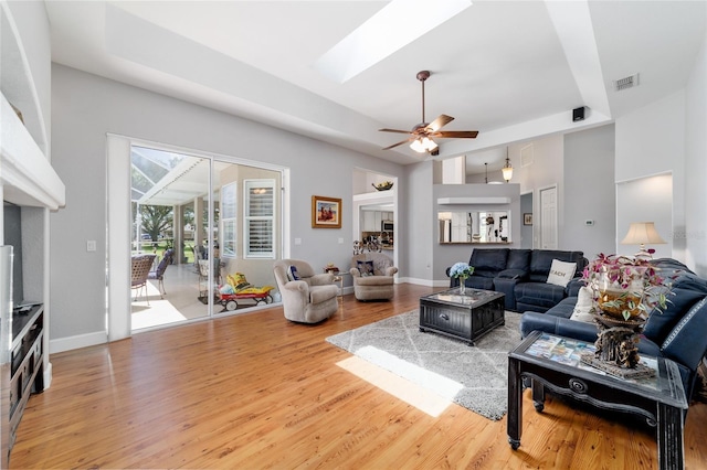 3629 SE 54th Ave, Ocala, FL 34480 - living room featuring light wood-type flooring, ceiling fan, a skylight, and a high ceiling