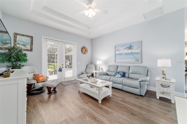 3629 SE 54th Ave, Ocala, FL 34480 - living area featuring a tray ceiling, french doors, light wood-style flooring, a ceiling fan, and ornamental molding