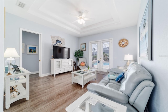 3629 SE 54th Ave, Ocala, FL 34480 - living area with a raised ceiling, french doors, a ceiling fan, and light wood-style flooring