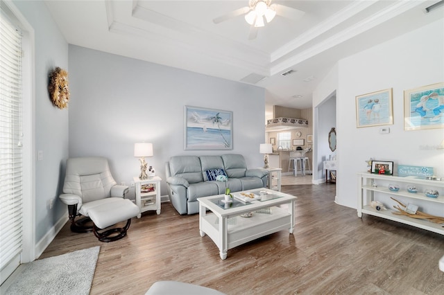 3629 SE 54th Ave, Ocala, FL 34480 - living area with a tray ceiling, ceiling fan, ornamental molding, and wood finished floors