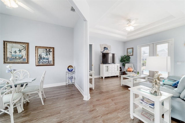 3629 SE 54th Ave, Ocala, FL 34480 - living area with ceiling fan, a tray ceiling, light wood-type flooring, and french doors