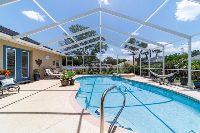 3629 SE 54th Ave, Ocala, FL 34480 - view of swimming pool featuring french doors, a patio area, a pool with connected hot tub, and glass enclosure