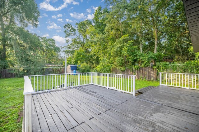 6021 NW 54th Ter, Ocala, FL 34482 - wooden terrace with a storage unit and a fenced backyard