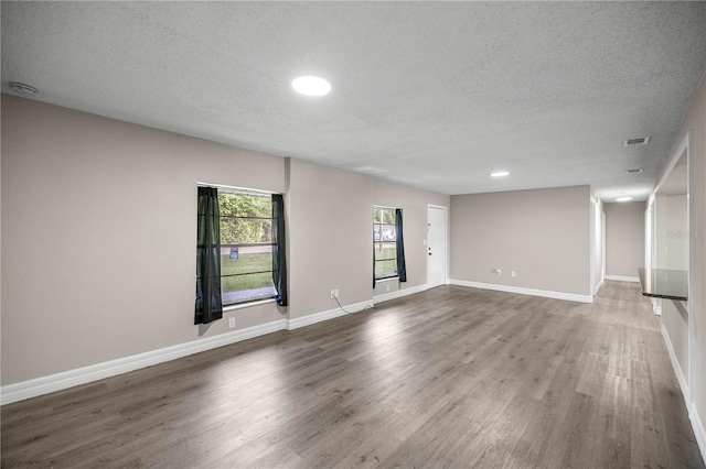 6021 NW 54th Ter, Ocala, FL 34482 - unfurnished living room featuring a textured ceiling, wood finished floors, and recessed lighting