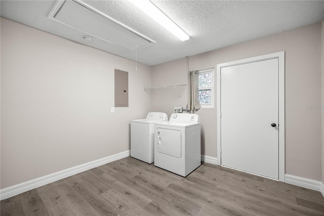 6021 NW 54th Ter, Ocala, FL 34482 - laundry area with attic access, electric panel, separate washer and dryer, light wood-style floors, and a textured ceiling