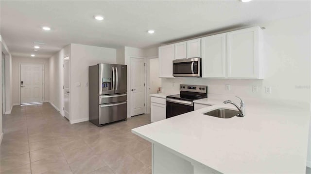 13267 SW 56th Ter, Ocala, FL 34473 - kitchen featuring appliances with stainless steel finishes, light countertops, recessed lighting, white cabinetry, and a peninsula