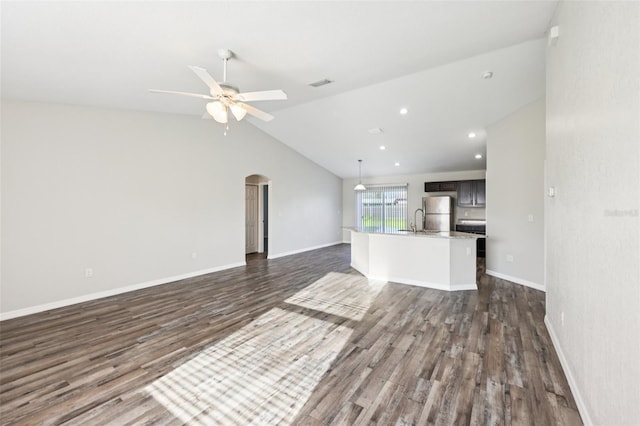 146 Juniper Loop Cir, Ocala, FL 34480 - unfurnished living room with dark wood-type flooring, arched walkways, ceiling fan, lofted ceiling, and recessed lighting