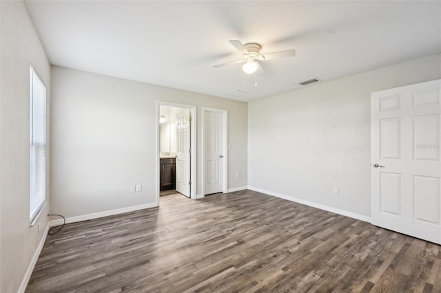 146 Juniper Loop Cir, Ocala, FL 34480 - unfurnished bedroom with dark wood-type flooring, a ceiling fan, and connected bathroom
