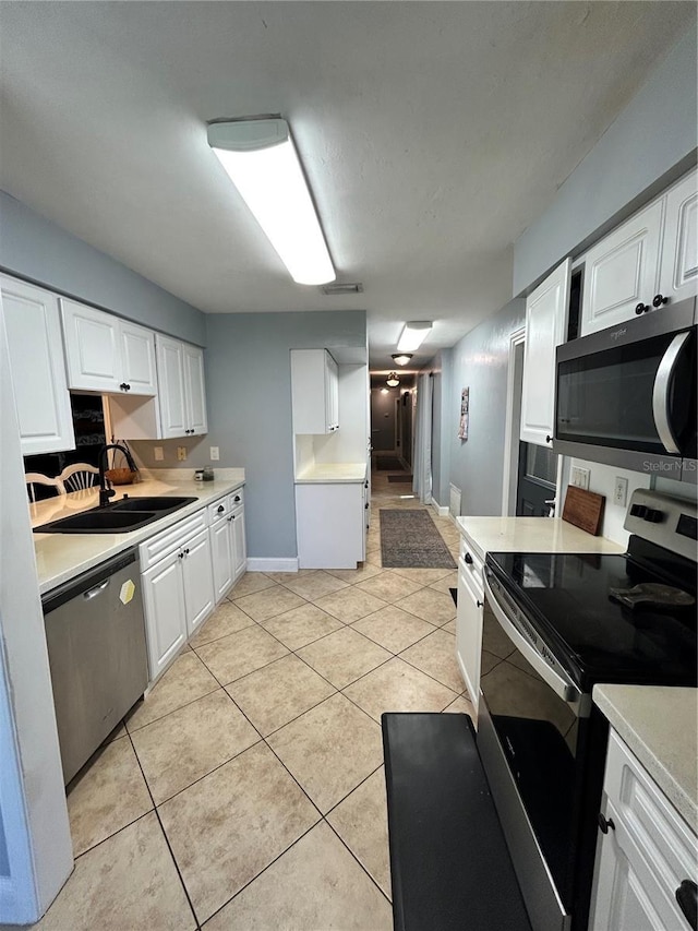 2070 SE 50th Ter, Ocala, FL 34480 - kitchen with stainless steel appliances, light countertops, and white cabinetry